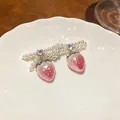Detailed view of pearl bow earrings with pink strawberry drops and zircon accents - Silver Earring Post - Silver - Pink