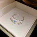 Detailed view of a sweet daisy flower ring with colorful gemstones in a gift box. - Adjustable Open Style (HR3569) / Silver (Blue/Pink/Purple Accents)