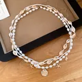 Detailed view of bohemian multi-layer pearl waist chain with shell and starfish pendants - 115cm / Gold-White