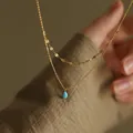 Double-layered gold stainless steel necklace featuring a small elegant blue teardrop pendant - Gold Necklace / Blue
