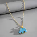 Detailed macro view of a cute blue resin elephant pendant on a gold necklace chain - Gold-Blue