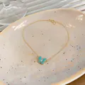 Close-up detail of a gold clavicle chain necklace featuring a teal butterfly pendant with zircon - Butterfly Pendant Clavicle Necklace / Gold (Blue Wings)