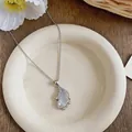 Macro view of an elegant zircon-studded feather necklace with delicate mother-of-pearl inlay - Silver