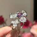 Close-up of a floral zircon ring with a purple center stone and adjustable band - Purple Floral Style (WR280-1) / Silver
