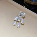 Exquisite detailed macro shot of a pearl bear jewelry charm featuring a sparkling zircon heart - Ear Clip (HR3492 HE33877) / Silver