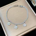 Macro view of a shimmering silver tennis bracelet featuring three zircon-studded eye charms - 18K Gold Plated / Silver-White