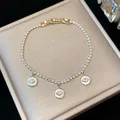 Detailed view of this 18k gold plated bracelet featuring zircon eye charms and chain - 18K Gold Plated / Gold-White