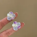 Close-up view of elegant ice-translucent crystal flower stud earrings with pearls. - Silver Earring Post Style / Lavender