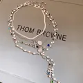 Detail view of multi-layered silver necklace with pearls and cross pendant - Choker Necklace / Silver