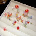 Close-up of handmade resin flower tassel earrings with colorful crystal beads and pearls - Flower Tassel Style / Colorful