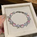 Elegant silver-tone bracelet with sparkling pink oval zircons and flower patterns - Silver Bracelet / Pink