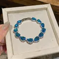 Elegant silver bracelet featuring vibrant blue pear-cut zircons in a velvet gift box - Silver Bracelet / Green