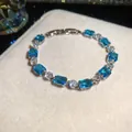 Elegant silver-tone fashion bracelet featuring radiant blue and clear zircon stones. - Silver Bracelet / Blue