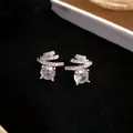 Macro view of exquisite silver needle stud earrings with round zircons and twisted design - S925 Silver Needle Style / Silver