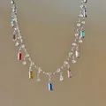 Close-up of elegant silver necklace with vibrant multi-colored baguette-cut stone charms - Choker Necklace / Gold-Multicolor