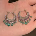 Macro view of zirconia hoop earrings with green teardrop tassel pendants. - Round Tassel Waterdrop Style (HE33308) / Gold-Purple-Green