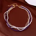 Elegante collana multistrato con perle bianche, perle di vetro viola e catenine dorate. - Stile di Perline Impilate Multistrato / Oro-Bianco-Viola
