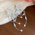 Elegant flower tassel earrings with pearls in French holiday style. - White