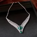 Detailed view of 18k gold plated necklace with green emerald-cut zircon centerpiece. - Vintage V-Shape Choker / Silver-Blue