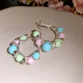 Close-up of elegant silver hoop earrings with pastel beads and sparkling crystals - 925 Sterling Silver Post - Pink Blue Green