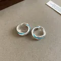 Minimalist silver oval hollow hoop earrings featuring turquoise blue bead accents for women - Hoop Hollow Style