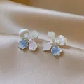 Close-up of elegant flower earrings with blue and pink crushed ice textures and central pearl - Flower Stud Earrings / Silver/Pink/Blue