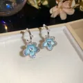 Detailed macro shot of elegant light blue flower earrings featuring zircon and pearls - 25# Silver Blue