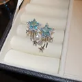 Detailed macro view of blue star-shaped zircon earrings with shooting star trail - 16# Ear Hook - Silver/Blue