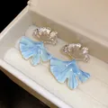Detailed macro view of blue marble texture ginkgo leaf stud earrings in jewelry box - 26# Silver Needle - Silver - Blue