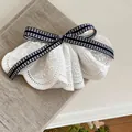 Exquisite close-up of white ruffled lace hair clip with a classic black and white checkered bow. - Duckbill Hair Clips / 1 Piece / Blue Plaid