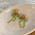 Detailed close-up of handmade fabric flower earrings featuring green glass bead tassels - Yellow & Green