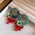 Detailed view of New Chinese style earrings with marbled green rings and red tassels - Hook-Blue-Red
