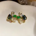 Elegant floral stud earrings with green beads and pear-shaped crystals on white dish. - 40# Silver Needle - Gold - Blue - Green