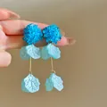 Close-up of blue hydrangea petal tassel earrings with textured finish and golden rods - 1# Hydrangea Style (HE32382) / Blue