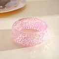 Macro detail of a thick iridescent pink resin bangle with sparkling interior shards - Pink