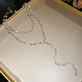 Close-up of double-layer necklace with elegant white glass beads and silver chain - Eco-friendly Style / Silver, White