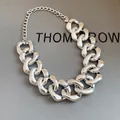 Detailed view of a chunky silver metallic chain necklace with a polished finish. - Silver Chunky Chain Choker / Silver