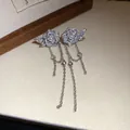 Close-up of elegant flower tassel earrings with pearls and shimmering zircons. - Rose Tassel Style / Silver