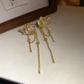 Close-up of elegant gold-plated rose earrings with pearls, zircons, and long tassels - Rose Tassel Style / Gold