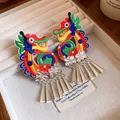 Detailed view of embroidered dragon earrings with silver tassels in a vintage style. - Dragon Tassel Ear Clip Style / Colorful