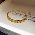 Detail shot of an 18K gold-plated bangle with a hollow geometric design and zircons - Double Layer Square Hollow Style