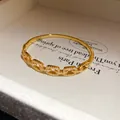 Close-up of 18K gold plated bangle with sparkling cubic zirconia links. - Rectangular Hollow Style