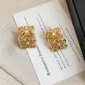 Boucles d'oreilles fleurs ajourées dorées élégantes avec des accents de zircone - Or