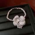 Close-up of silver-tone flower necklace pendant with sparkling cubic zirconia stones - Bracelet Only (Without Necklace) / Silver
