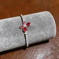 Detail of butterfly motif on silver bracelet with red and white sparkling zircons - Waterdrop Butterfly Bracelet (5)