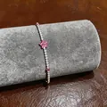 Macro detail of an elegant pink flower zircon bracelet displayed on grey velvet roll - Five-Petal Flower Bracelet (4)
