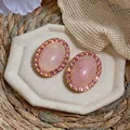Vintage style oval pink acrylic stud earrings with sparkling crystal halo on beige pad - Silver Earring Post - Gold - Pink