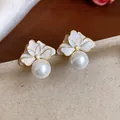 Detailed shot of elegant French style flower stud earrings with white enamel and hanging pearl - Flower Pearl (HE31413) / Gold-White