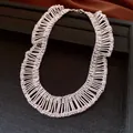 Macro view of elegant pleated silver fringe necklace showing intricate metallic beadwork. - Necklace / Silver