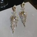 Elegant long geometric tassel earrings featuring sparkling water drop crystals in gold. - Long Water Drop Tassel Style (59#)
